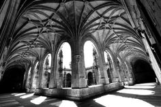 the inside of an old cathedral with many arches