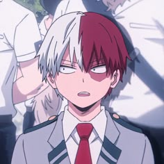 an anime character with red hair wearing a suit and tie in front of other people