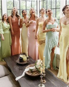 a group of women standing next to each other in front of a table with candles