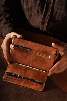 Discover our vintage leather wallet, meticulously crafted to offer both style and practicality. This premium genuine leather wallet is a must-have accessory for those who value quality and sophistication. Handcrafted Genuine Leather: Our wallet is made from high-quality, durable leather, ensuring a timeless and elegant look that stands the test of time. Each wallet is meticulously handcrafted by skilled artisans, giving it a unique touch and superior craftsmanship. The natural grain of the leather adds character, making each piece one-of-a-kind. Large Capacity: Designed with multiple compartments, this wallet provides ample space to hold all your essentials. It features a main compartment for bills, a zippered pocket for coins, and several slots for receipts or small papers. This thoughtfu Character Making, Fly Shop, Large Wallet, Genuine Leather Wallets, Small Leather Goods, Long Wallet, Leather Handbag, Vintage Leather, Leather Craft