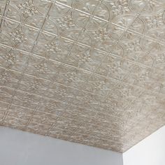 the ceiling is decorated with intricate designs and lines in silver color, as well as white walls