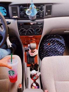 the interior of a car with various items in it