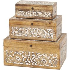 three wooden boxes are stacked on top of each other, one with an intricate design