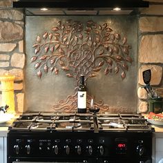 a stove top oven sitting next to a wall mounted wine bottle on it's side