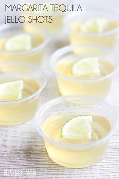 margarita tequila jello shots in plastic cups with lime wedges