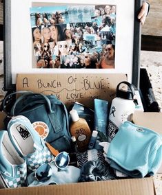 a bunch of blue items in a cardboard box with pictures on the wall behind it