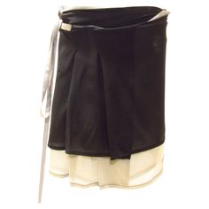 A delicate silk wrap mini skirt is black with a light grey layer beneath. It features a back pocket with flap and red stitching at back label. Black Mini Wrap Skirt With Lining, Yohji Yamamoto Street Style, Street Style Skirt, Black Wrap Skirt, Wrap Mini Skirt, Paneled Skirt, Fashion Sites, Silk Wrap, Yohji Yamamoto