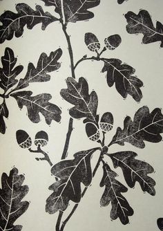 a black and white drawing of leaves and acorns on a wallpaper background