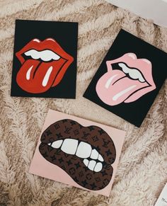 three paintings of different lips on a bed