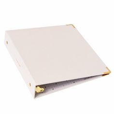 a white binder with gold handles on a white background