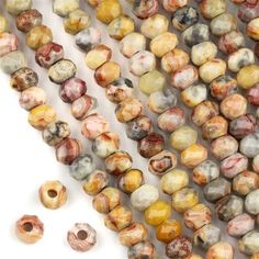 two strands of brown and white marble beads with holes in the middle, on a white background