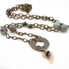 This turquoise Agate necklace features beautiful faceted light turquoise blue with brown veining Agate gemstones with vintage accent beads along with a unique brass verdigris pendant with a copper leaf charm. The antique brass etched cable chain in this long boho necklace is made of high quality brass and can easily be slipped on/off over your head, therefore no need for a clasp. For an effortlessly chic look wear this one-of-a-kind gemstone beaded necklace alone or layered with other boho style Bohemian Czech Glass Bronze Necklace, Bohemian Turquoise Pendant Necklace With Patina, Spiritual Bronze Necklace With Patina, Spiritual Patina Copper Necklace, Bohemian Agate Necklace In Bronze, Bohemian Copper Necklace With Patina, Bronze Copper Necklace With Patina, Bohemian Bronze Agate Necklace, Bronze Agate Bohemian Necklace