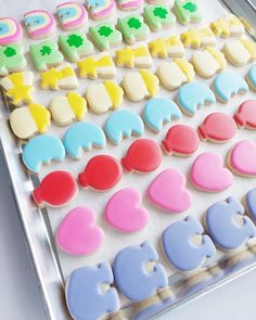 decorated cookies in the shape of letters on a tray