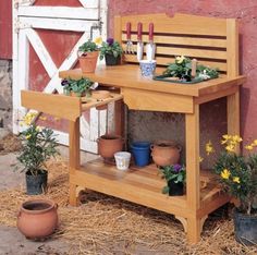 a wooden bench with potted plants on it