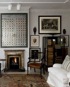 a living room filled with furniture and a fire place in the middle of the room