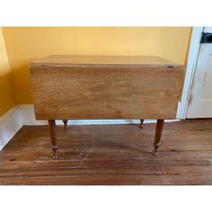 an old wooden chest sitting on top of a hard wood floor next to a door