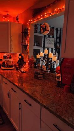 the kitchen counter is covered with candles and decorations