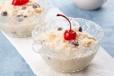 two small bowls filled with food on top of a table