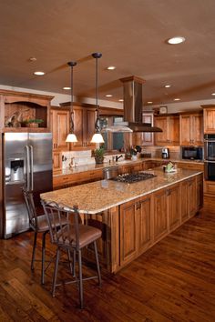 a large kitchen with wooden cabinets and stainless steel appliances