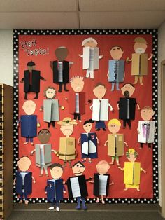 a bulletin board with cut out people on it