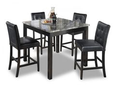 a marble top dining table with black leather chairs