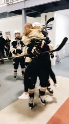 the hockey players are hugging each other on the ice