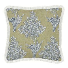 a green pillow with blue and white flowers on it