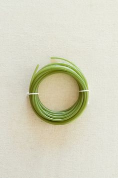 a green wire on a white surface