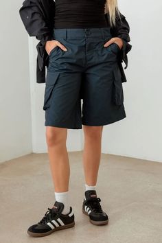 Cargo Shorts Keep it cool and stylish with these Navy Cargo Shorts. Ideal for your casual summer days, these shorts bring a trendy and relaxed vibe to your look. The cargo style adds practicality and utility, making it easy to keep your essentials within reach. The navy color is versatile and pairs well with all your favorite tops. Whether you're running errands or spending a day by the beach, these Bermuda shorts are a must-have for your warm-weather wardrobe. Match them with a tank top and san Summer Knee-length Cargo Shorts With Hip Pockets, Utility Bermuda Bottoms With Built-in Shorts, Utility Bermuda Shorts With Built-in Shorts, Knee-length Shorts For Summer Outdoor Activities, Summer Outdoor Knee-length Shorts, Spring High-waisted Bermuda Shorts With Cargo Pockets, Trendy High-waisted Cargo Shorts With Side Pockets, Summer Bermuda Shorts With Cargo Pockets, Spring Outdoor Cargo Knee-length Shorts