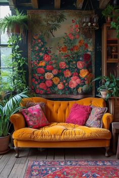 an orange couch in front of a painting and potted plants