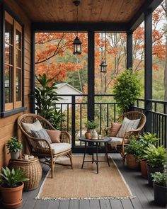 a porch with wicker furniture and potted plants