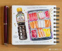 a drawing of sushi and sauce on a notebook next to a pen, which is sitting on a table