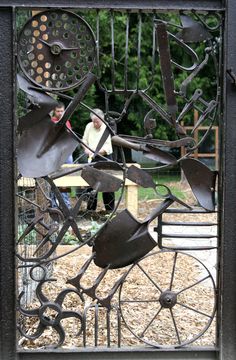 an iron gate that has been made to look like it is being used as a sculpture