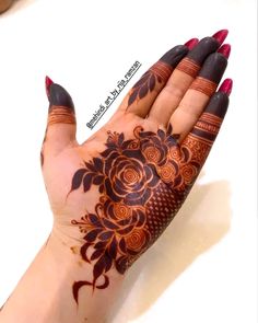 a woman's hand with henna tattoos on it