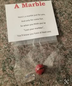 a card that has been placed on top of a marble counter with a red heart in it