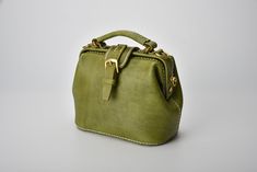 "*DOCTOR BAG'S HANDMADE VIDEO* https://youtu.be/QpdhSCjh2BM Product Description * Material: vegetable tanned leather * Color: Hand-dyeing -olive green * Flap over entry with magnetic buckle closure * 0.75\" wide leather shoulder strap adjust from 36.61\" to 44.88\" * Sewn by hand; * Size: 170mm (H) x 180mm (W) x 110mm (D) / 6.7\" x 7.0\" x 4.3\" The Installation of Doctor Bag Frame #Please see the last picture# Doctor Bag Frame is connected by two pairs of screws. Although we will tighten the sc Leather Handbags Handmade, Purse Insert, Italian Bags, Bag Designs, Women Leather Backpack, Doctor Bag, Bag Green, Printed Bags, Vegetable Tanned Leather