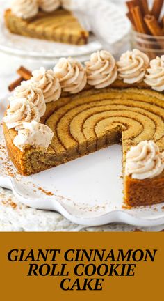 a close up of a cake on a plate with the words giant cinnamon roll cookie cake