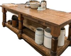 an old wooden table with some buckets and bowls on it's top shelf