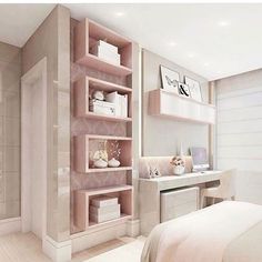 a bedroom with a bed, desk and shelving unit in the middle of it