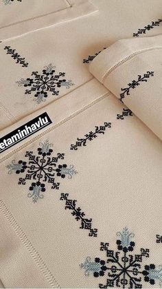 an embroidered sheet with snowflakes on it and the words staninhayu written in black