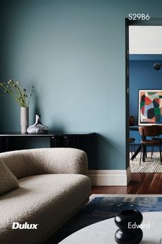 a living room filled with furniture and blue walls