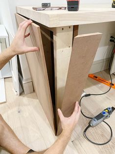 a man is working on an unfinished table