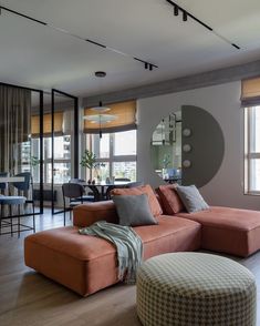 a living room filled with furniture and windows