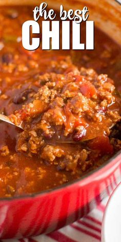 a spoon full of chili soup in a red bowl with the words, the best chili