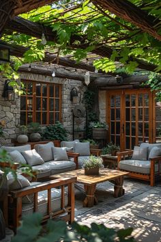 an outdoor living area with couches and tables