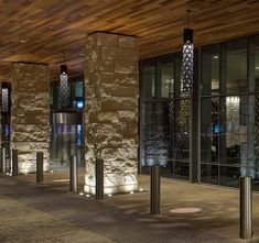 an empty lobby with glass doors and lights