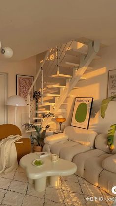 a living room filled with furniture and a stair case