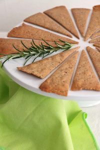 crackers are arranged on a plate with rosemary sprigs