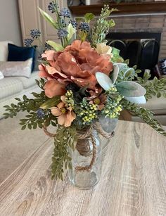 a vase filled with flowers sitting on top of a table next to a fire place