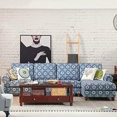 a living room filled with furniture and a painting on the wall above it's couch